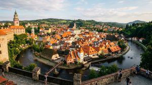 Panoramic view of Cesky Krumlov medieval town and castle tower overlooking the horseshoe bend of the Vltava River in South Bohemia (AI Generated Image)